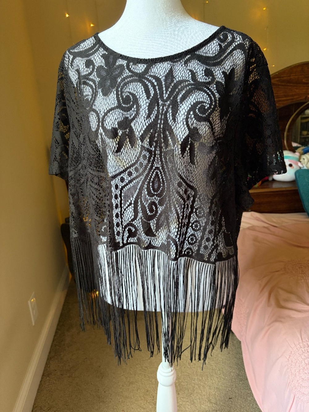 This plus-size poncho top is crafted from a completely sheer with beautiful lace